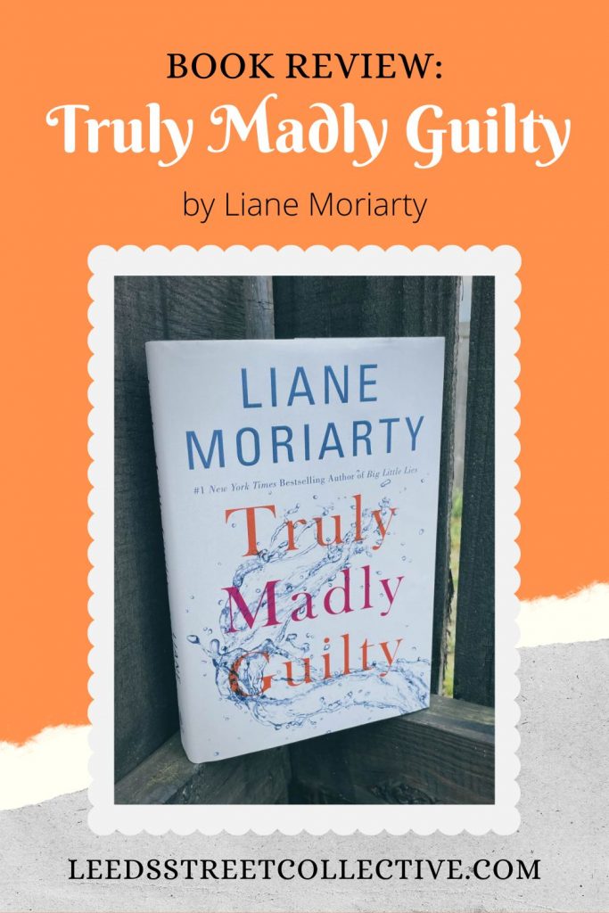 photo of the cover of Truly Madly Guilty by Liane Moriarty leaning up against a gray weathered fence